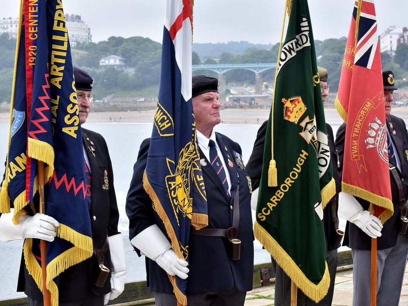 Standard bearers reflect on the pier.