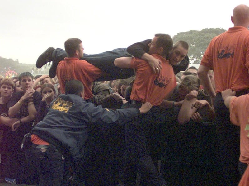 Security take a fan out of the crowd whilst Bradford band Terrorvison are on stage.