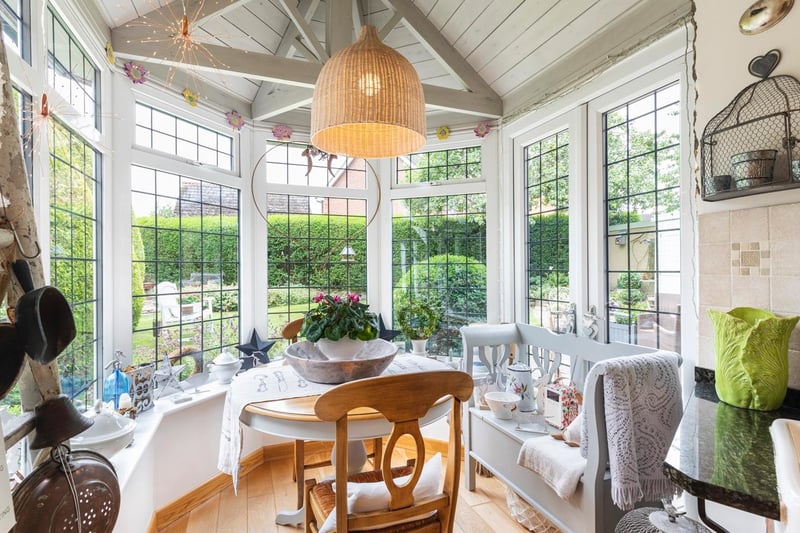 To the left of the kitchen space is the quaint dining area, which is located in a small snug with large windows offering stunning views across the garden.