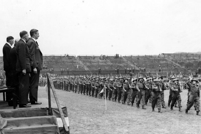 Anthony Eden observes a march past of troops.