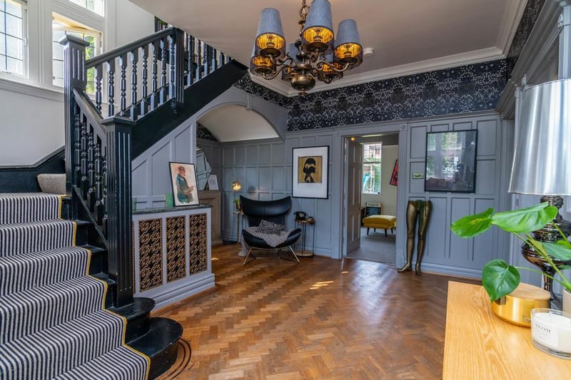 Inside, you are met with the the incredibly impressive entrance hallway with its grand staircase, shaker panel walls, original stone fireplace and parquet flooring.