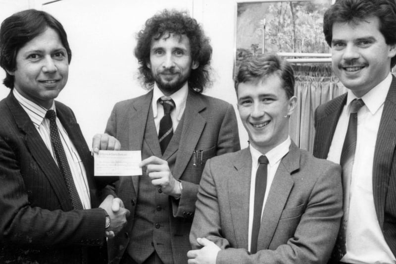 Dr Nayyar Naqvi accepts a cheque for his Heartbeat fund at Wigan Infirmary in 1985.