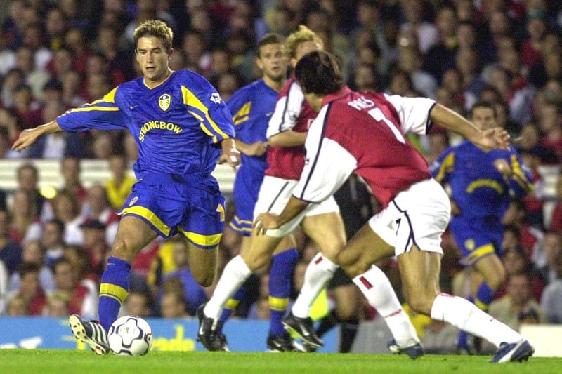 Harry Kewell on the charge as Arsenal's Robert Pires closes in.