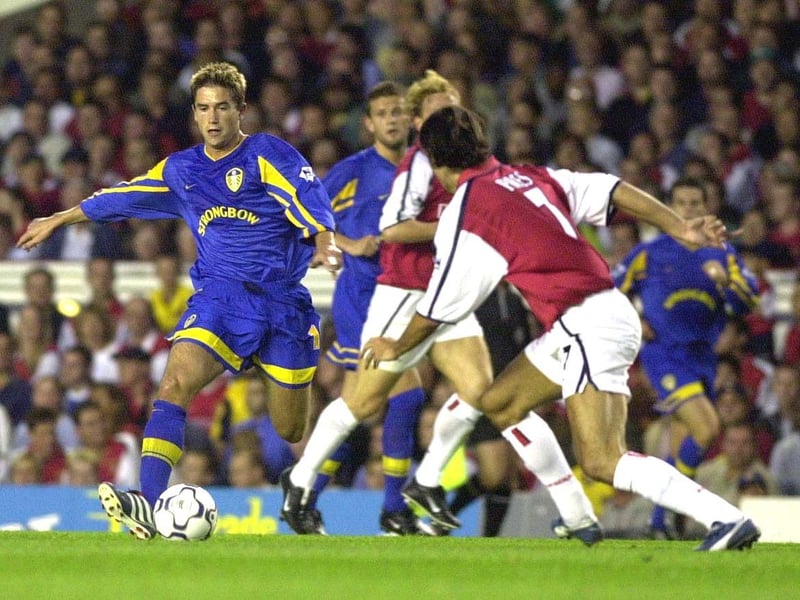Harry Kewell on the charge as Arsenal's Robert Pires closes in.
