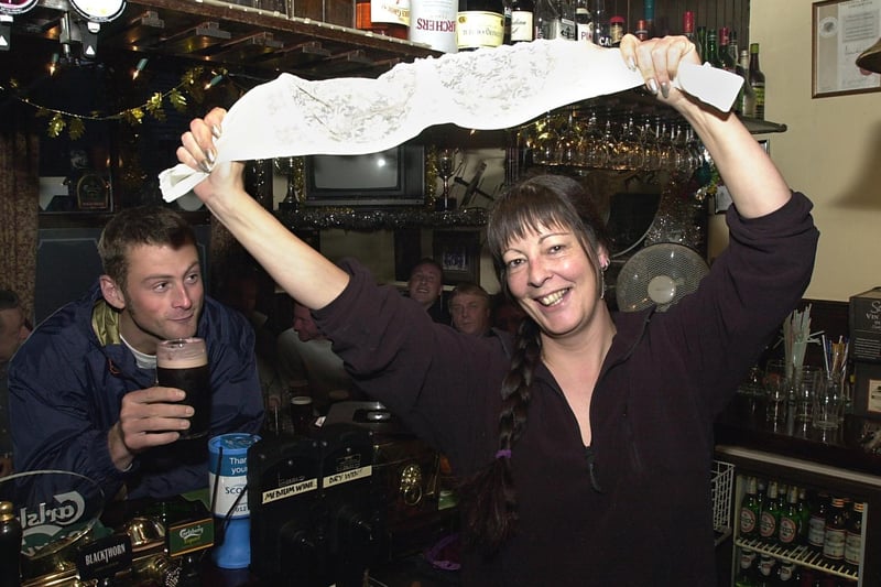Landlady Jude Caldwell, pictured behind the bar at the Junction Inn, with one of her old bras in December 2001.