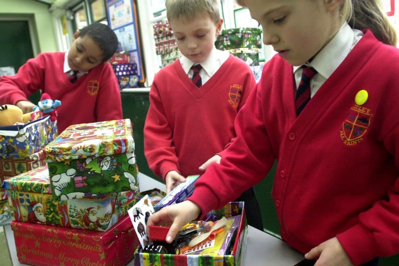 Pupils at Otley All Saints pack Christmas boxes for charity. Pictured, from left, are  Andrew Pollard, Rhys Walshaw and Alexia Latham.