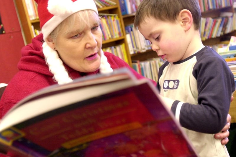 Barbara Taylor reads Christmas stories to Alec Maayeddi at Otley Library in December 2001.