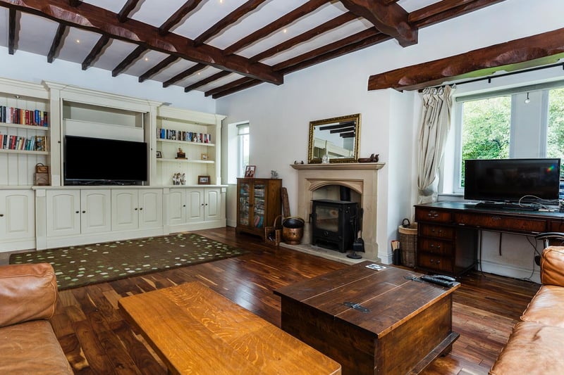 This characterful room has a feature fireplace and beams to the ceiling
