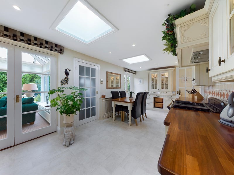 A spacious fitted kitchen with cream units.