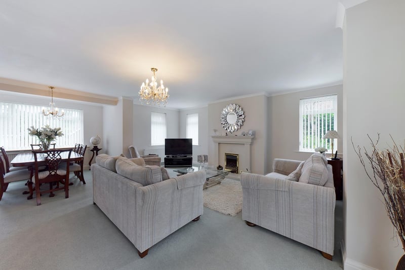 The stylish living room and dining area within the property