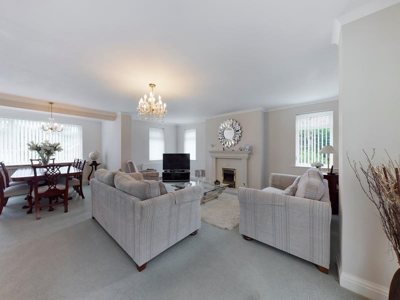 The stylish living room and dining area within the property