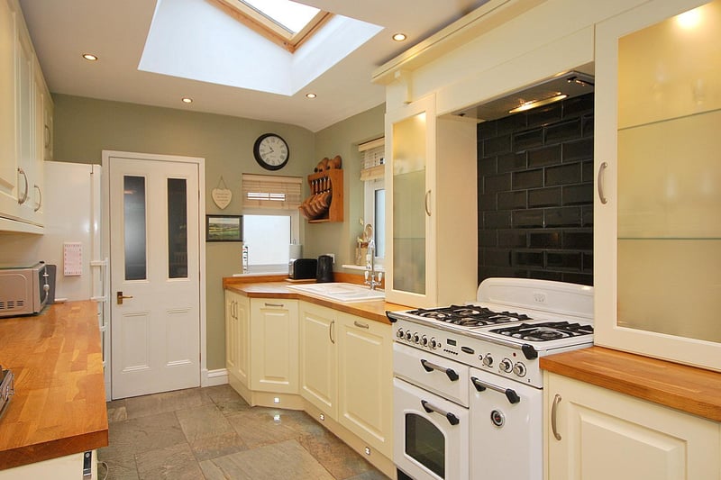 Fitted units and appliances within the stylish kitchen.