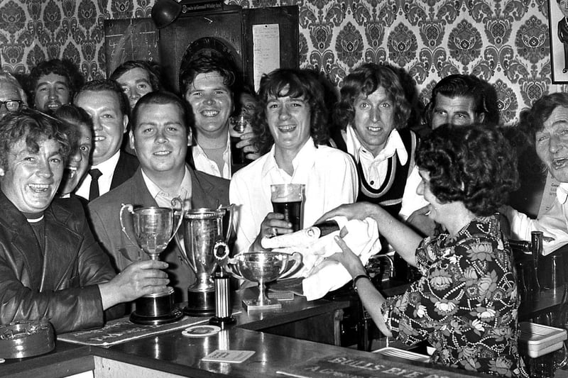 Regulars at the Anderton Arms line up at their annual presentation evening in 1973