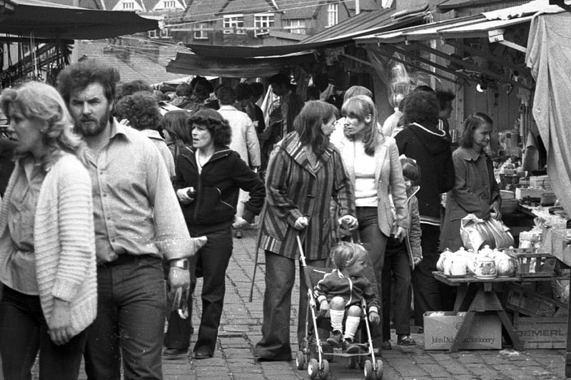 Customers have a look around Ashton market stalls in 1979