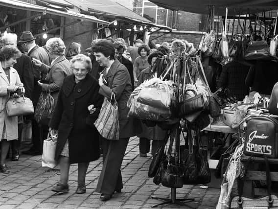 Customers have a look around Ashton market stalls in 1979