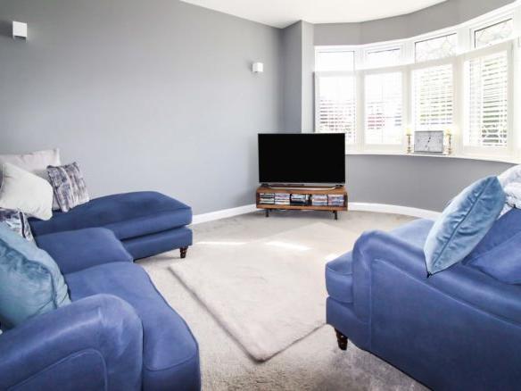 To the right is the separate lounge area, which has plenty of light flooding through the stunning bay windows.