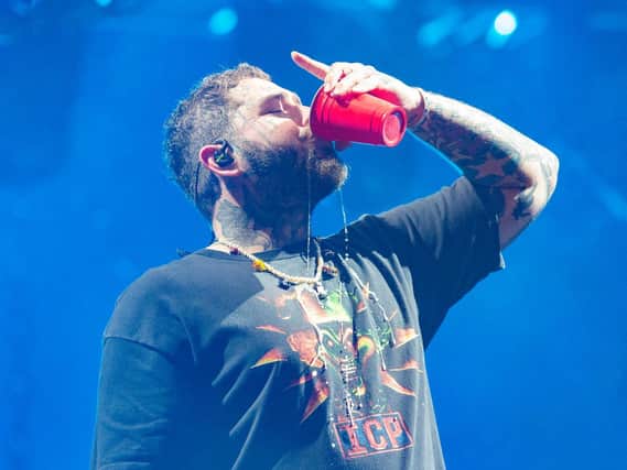 Post Malone chugs his drink on stage at Leeds Festival