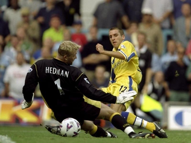 Darren Huckerby slips the ball past Magnus Hedman in the Coventry City goal.