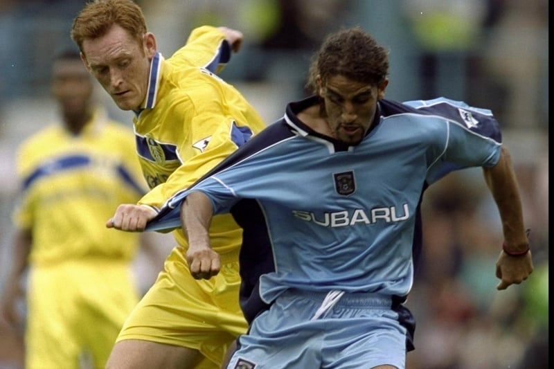 Coventry City's Mustapha Hadji holds off David Hopkin.