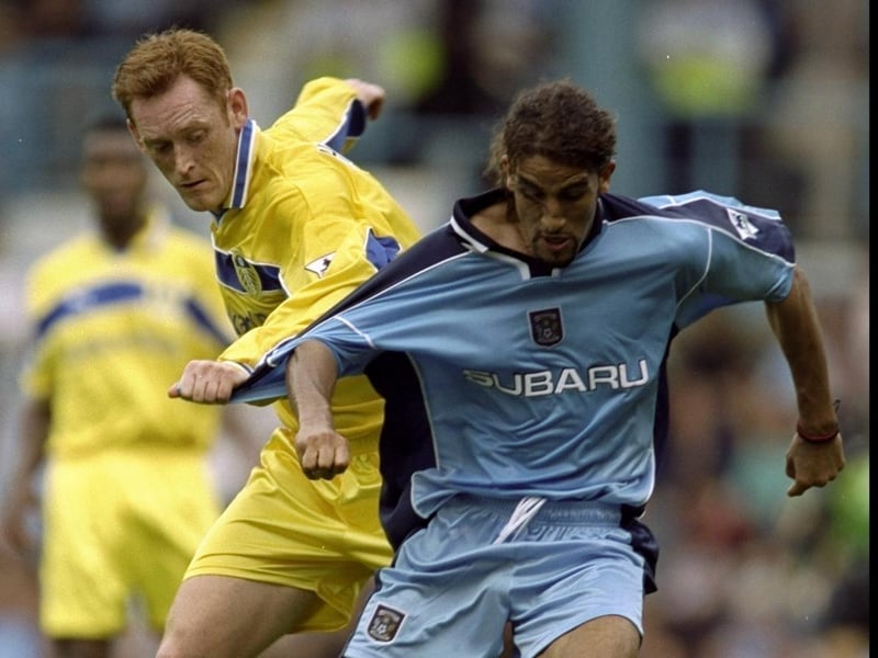 Coventry City's Mustapha Hadji holds off David Hopkin.