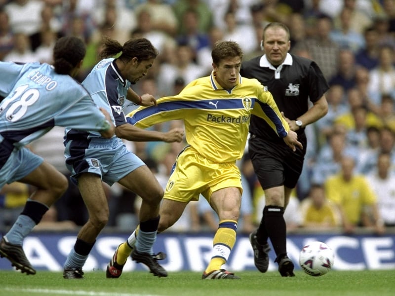 Harry Kewell is held back by Coventry City's Mustapha Hadji.