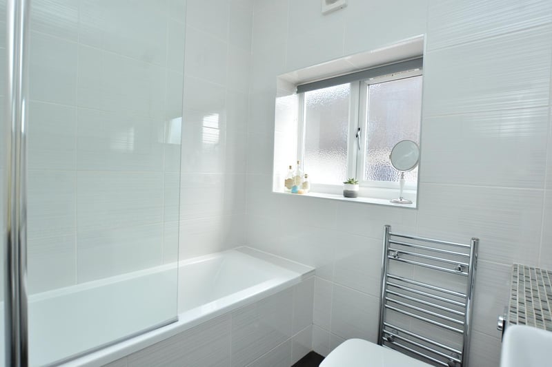 The house bathroom is fitted with a modern three piece white suite.