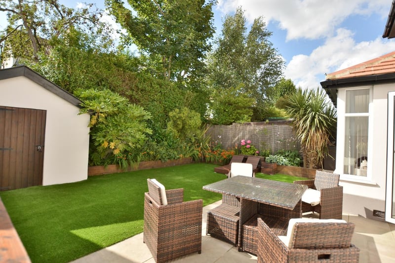 The enclosed back garden is west facing and easily maintained. It has a paved seating area and lawn laid in artificial turf with low borders of planting.