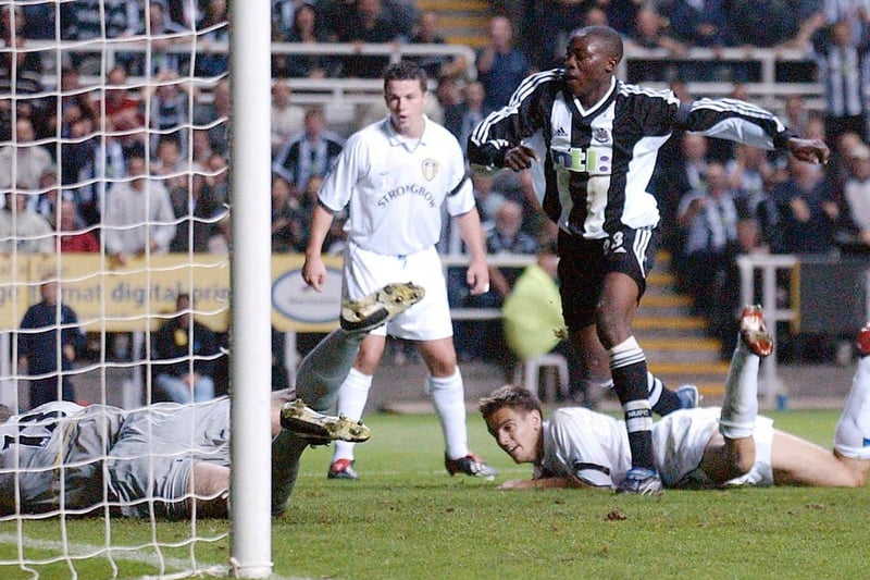 Goalkeeper Paul Robinson makes a point blank save from Newcastle United striker Shola Ameobi.