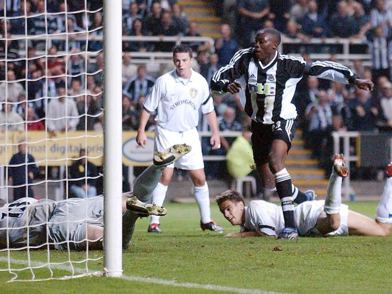 Goalkeeper Paul Robinson makes a point blank save from Newcastle United striker Shola Ameobi.