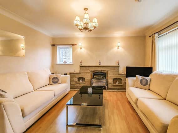This home benefits from two living areas. The main sitting room is currently set up with two large sofas and a television.