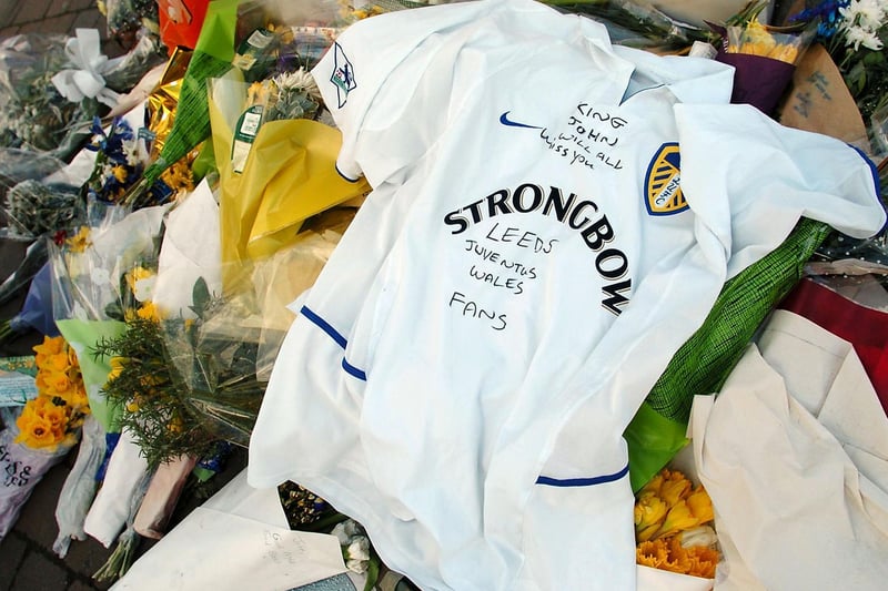 Flowers and a Leeds shirt are left by the Billy Bremner statue in memory former legend John Charles.