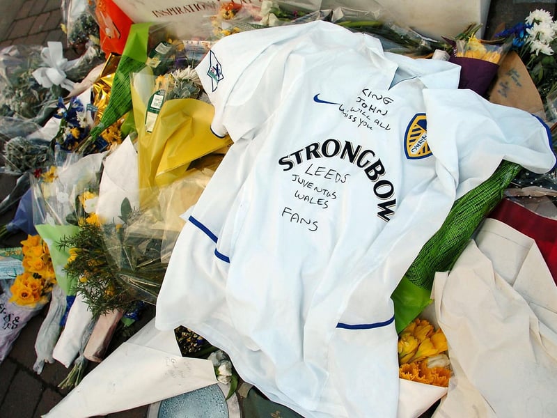 Flowers and a Leeds shirt are left by the Billy Bremner statue in memory former legend John Charles.