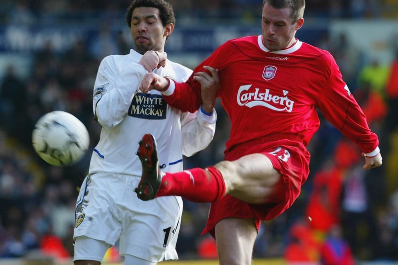 Liverpool's Jamie Carragher clears the ball as Jermaine Pennant closes in.