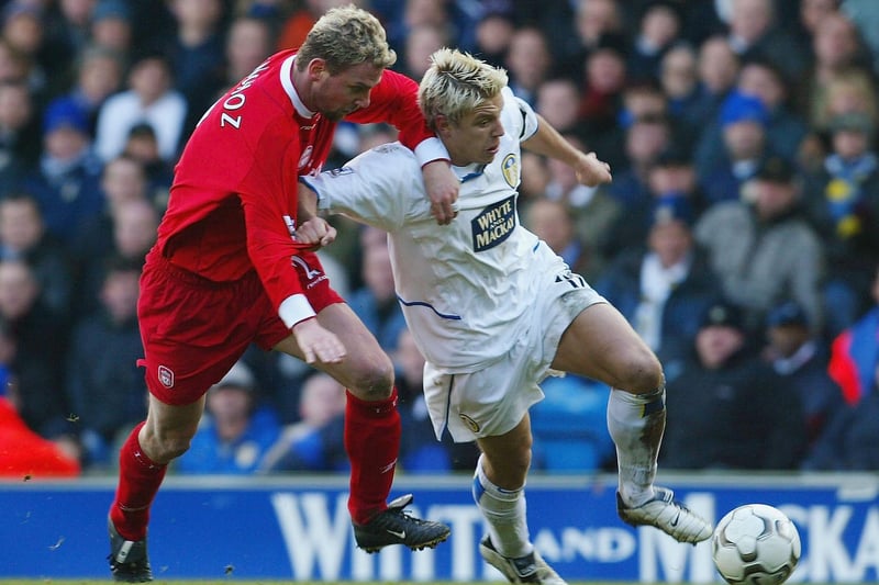 Striker Alan Smith protects the ball from LIverpool's Stepnane Henchoz.