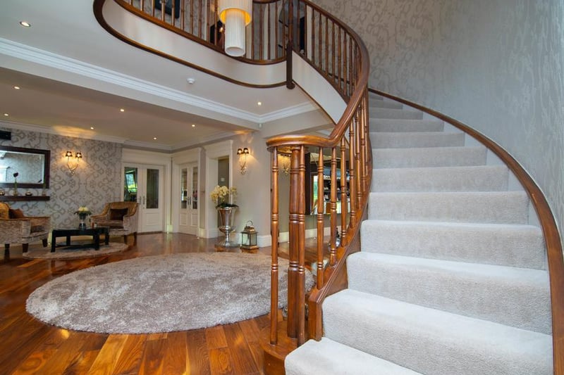 Enter into the outstanding reception hallway with a vanished hardwood flooring and a sweeping, bespoke staircase.
