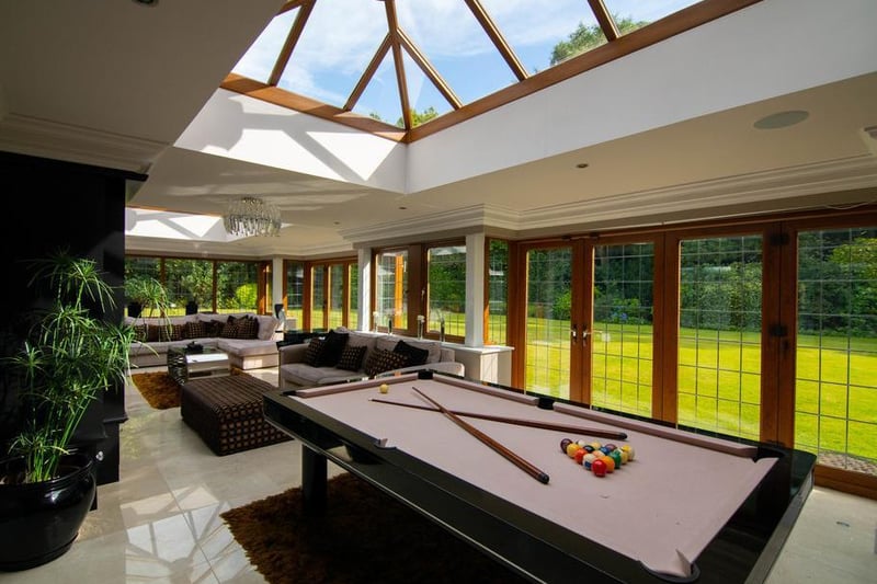 From the open plan kitchen/diner/living space is access to the orangery, which is currently used as a games room. This space benefits from feature glazing which provides views in to the leisure suite.