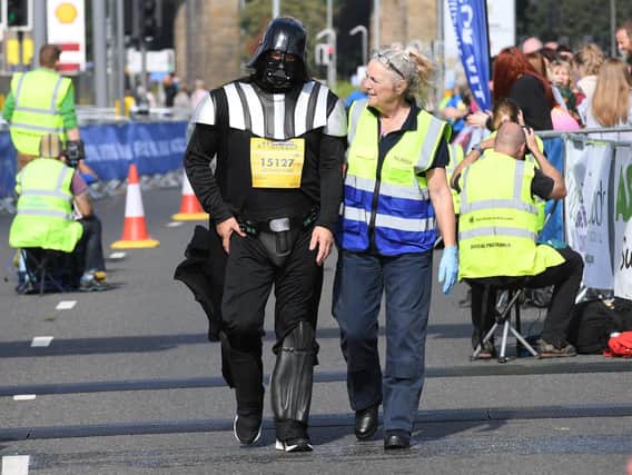 Darth Vader needs a little help crossing the finish line