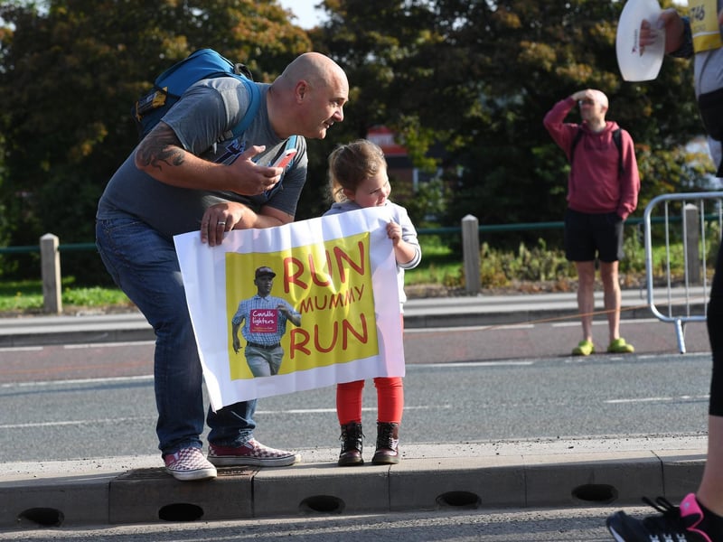 A little girl supports her mum from the sidelines