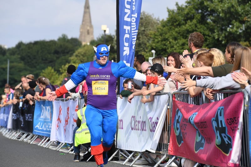 Captain America high fives the crowd as he jogs by