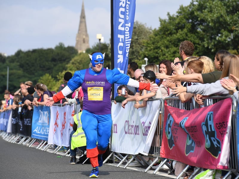 Captain America high fives the crowd as he jogs by