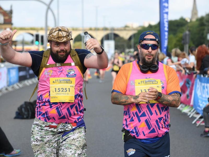 Two runners crossing the finish line