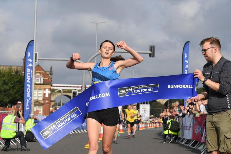 The winner of the women's race crosses the finish line