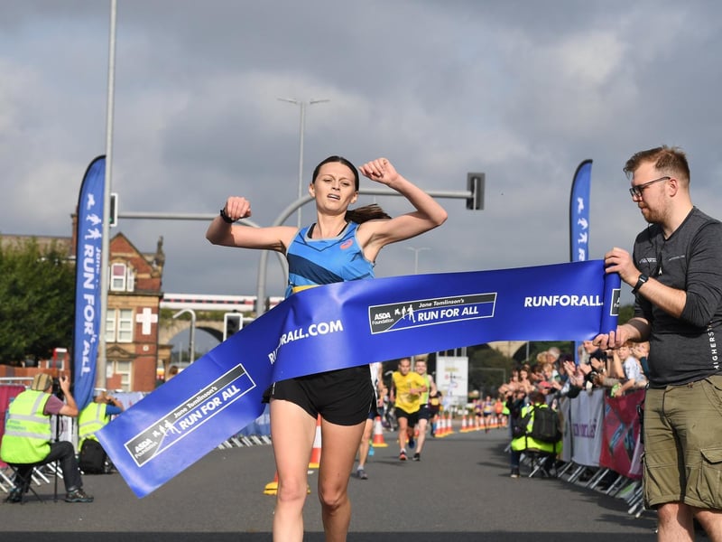 The winner of the women's race crosses the finish line