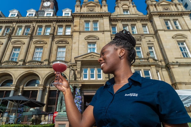 Daisy Aigbe-Joseph, at Banyan - Bar & Kitchen, City Square, Leeds, serves customers with cocktails to keep cool.