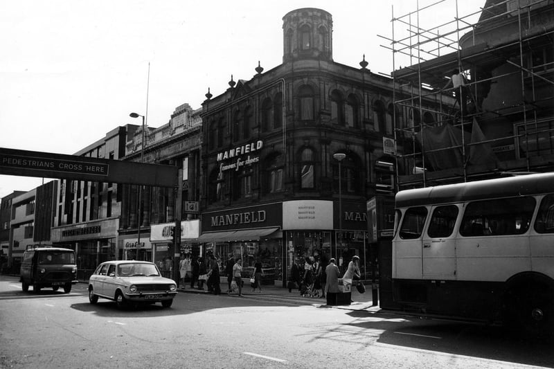 Briggate showing the junction with Commercial Street in June 1975. Pictured centre is Manfield footwear; to the left of this is Amber ladieswear, then Trueform footwear and Marks and Spencer.