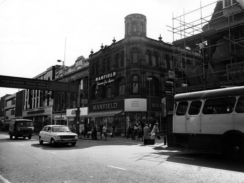 Briggate showing the junction with Commercial Street in June 1975. Pictured centre is Manfield footwear; to the left of this is Amber ladieswear, then Trueform footwear and Marks and Spencer.