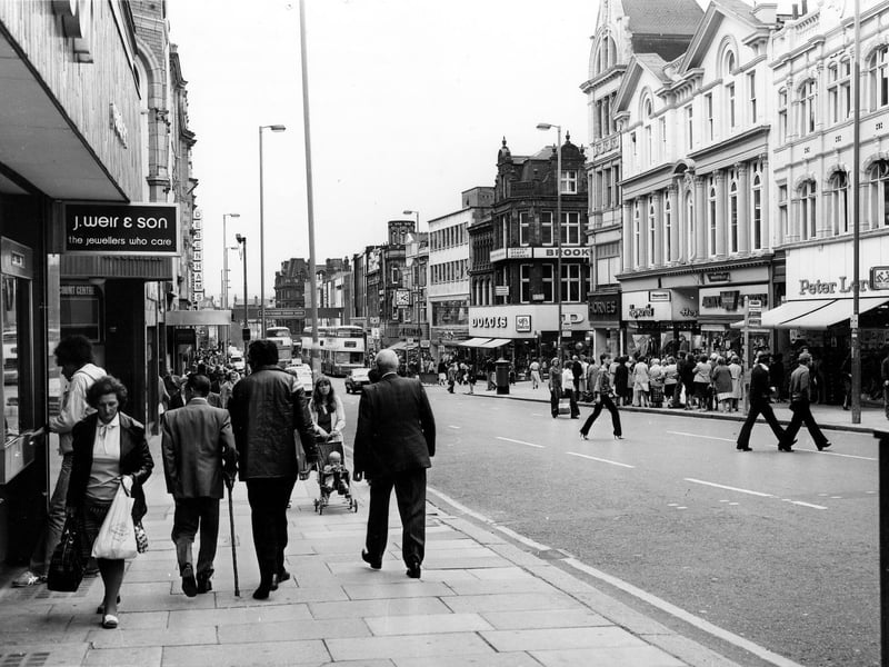 Briggate in April 1979. On the left is J.Weir & Son 'the jeweller's who care'. On the right, Dolcis shoe shop is visible on corner with Albion Place, then Hornes and Hepworths followed by the Army Stores and Peter Lord's far right.