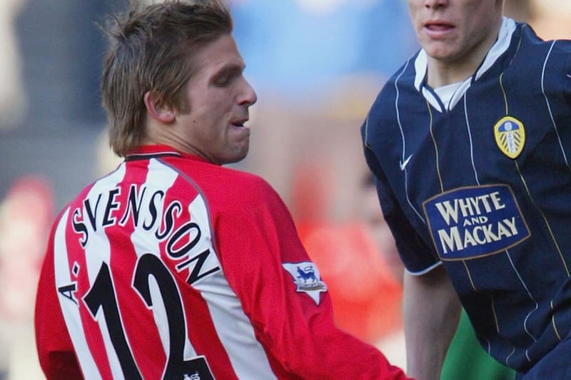 James Milner slips the ball past Southampton's Anders Svensson during the Premiership clash at St. Mary's Stadium in January 2004.