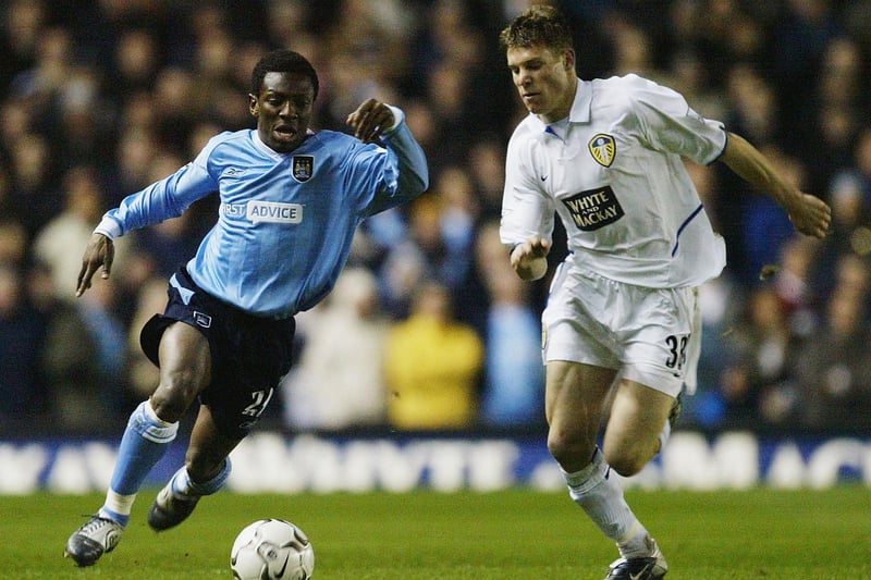 James Milner battles for the ball with Manchester City's Shaun Wright-Phillips during the Premiership clash at Elland Road in March 2004.