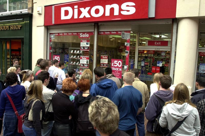 Crowds gather round a television outside the Dixon Electrical store on Briggate to witness the horrific events.